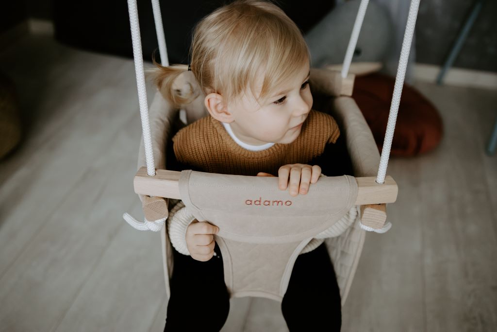 Child sitting in an Adamo swing