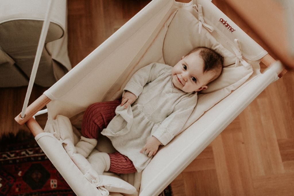 Baby laying in an Adamo swing