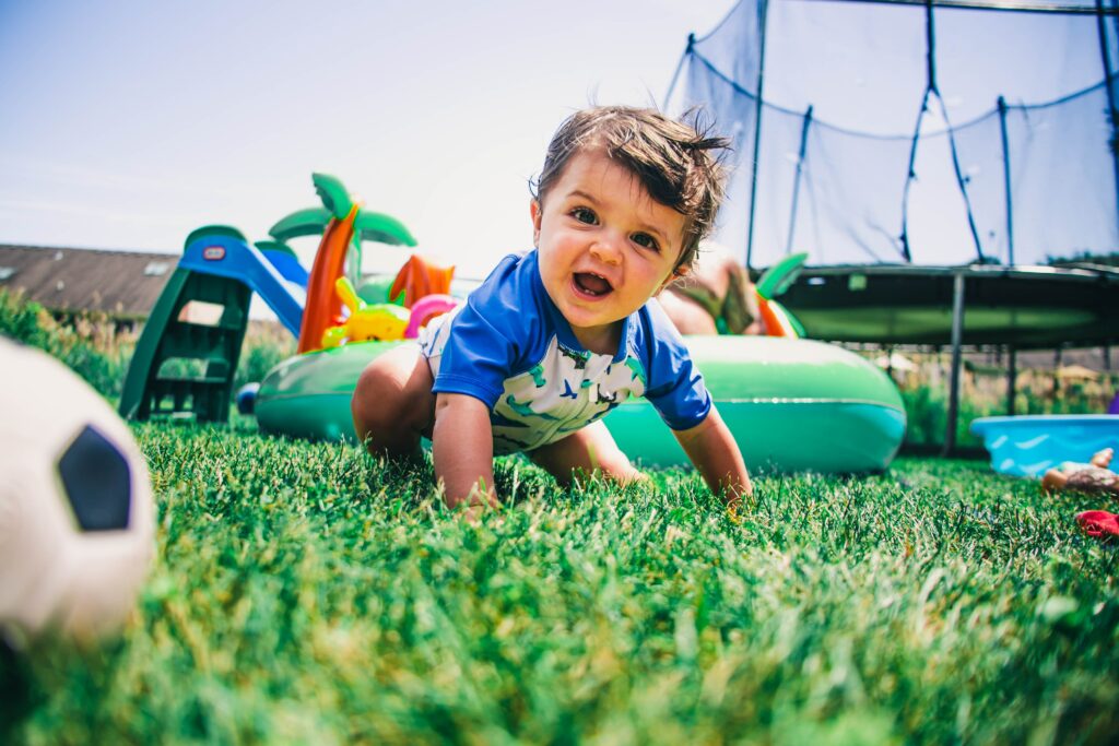 Toddler playing in the grass