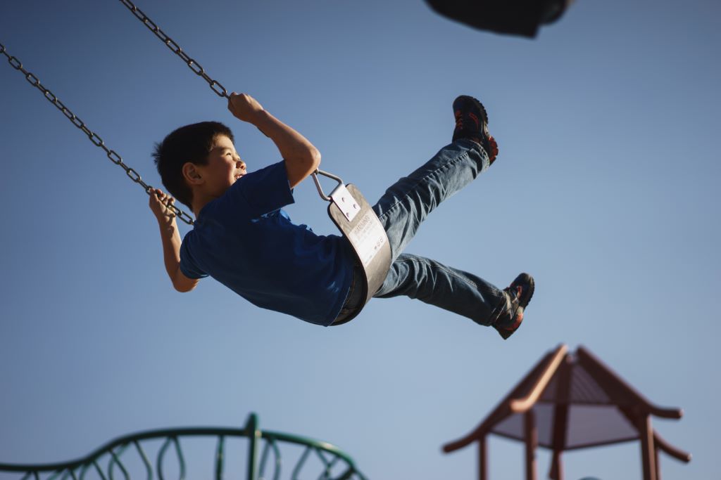 Child swinging on the playground